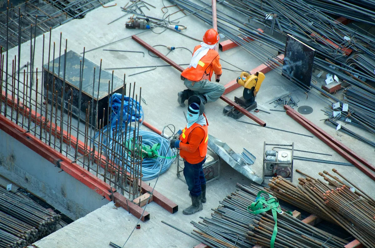 Tradespeople in hi-vis gear working on a construction job site